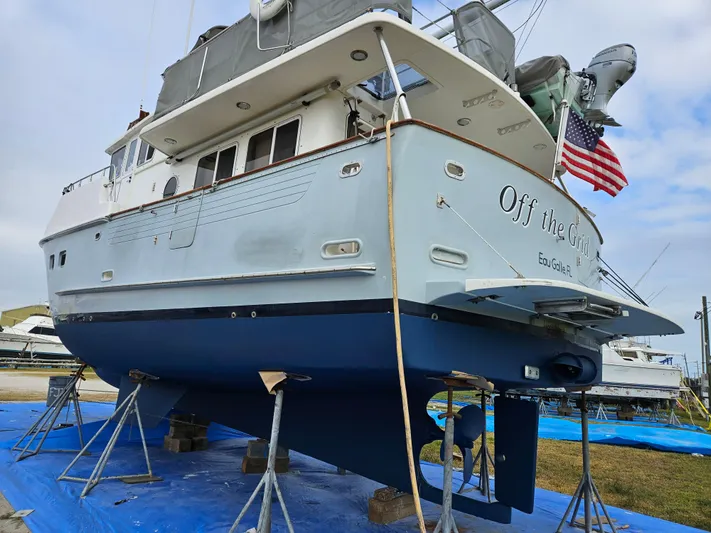 Off The Grid Yacht Photos Pics 2001 Selene Ocean Trawler on stands, displaying hull and propeller, with American flag.
