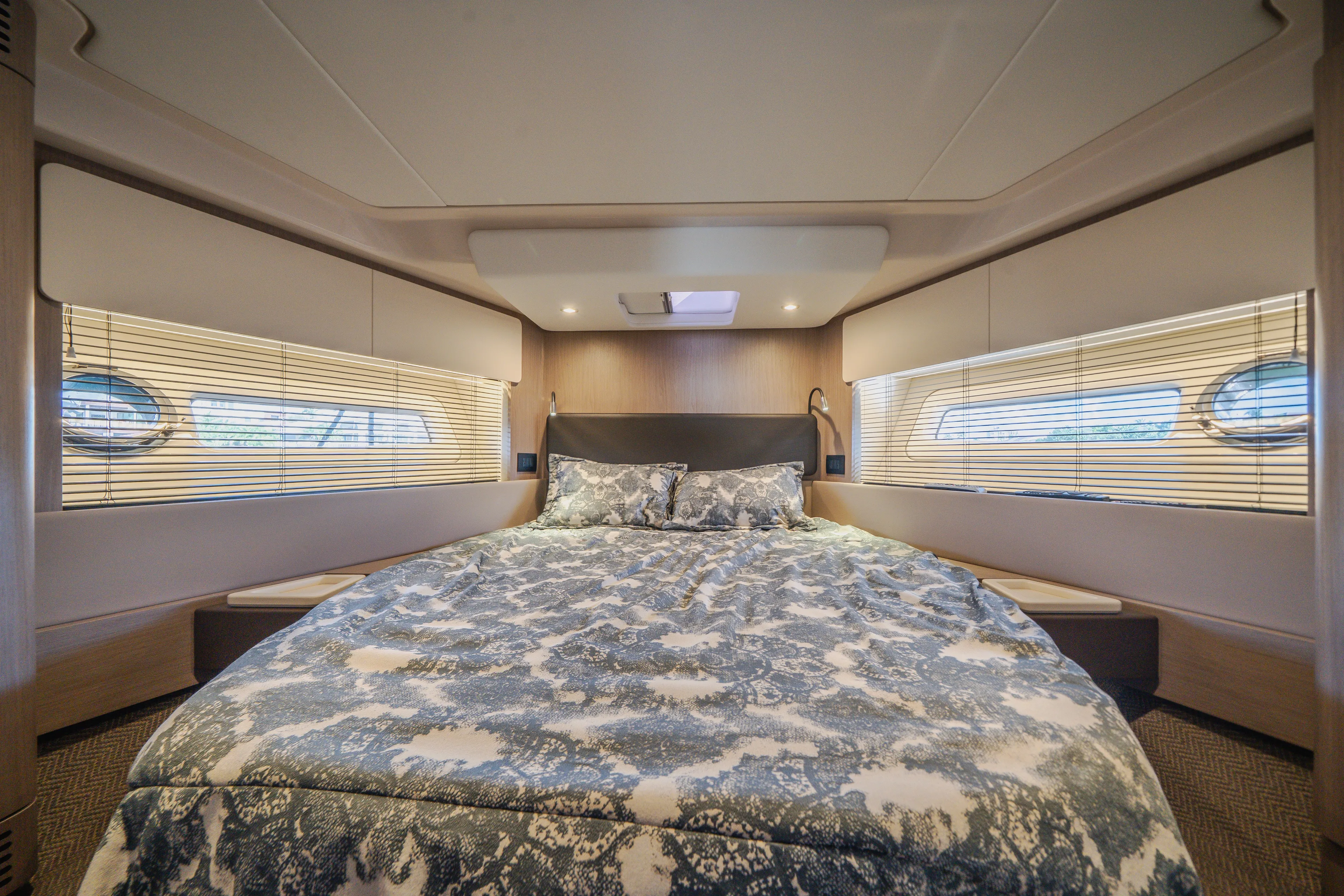  Yacht Photos Pics Luxurious bedroom interior of 2022 Azimut 50 Fly yacht with elegant bedding and modern design.