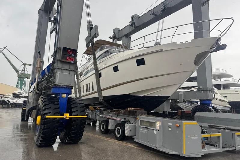  Yacht Photos Pics 2015 Fairline Squadron 65 yacht being lifted by a large crane in a shipyard.