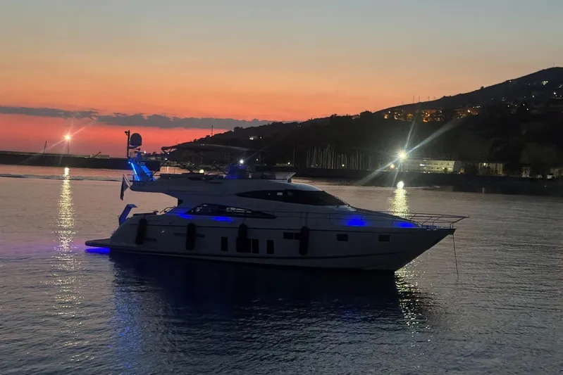  Yacht Photos Pics 2015 Fairline Squadron 65 yacht illuminated at sunset on calm waters.