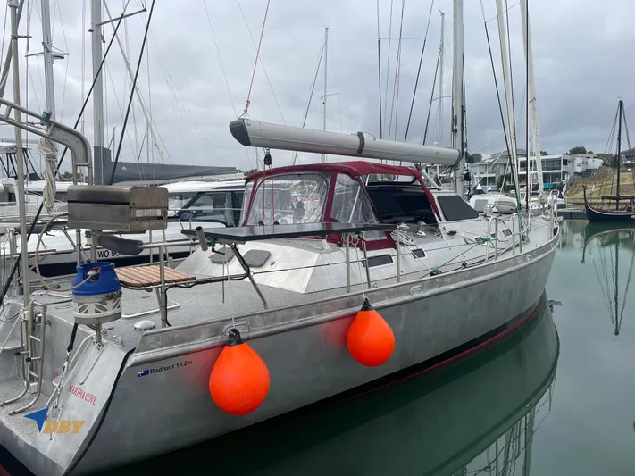 Rubicon Yacht Photos Pics 2022 Radford 15.2 yacht docked in marina with orange fenders and red canopy.