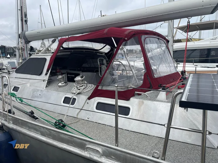 Rubicon Yacht Photos Pics 2022 Radford 15.2 sailboat with red canopy, docked at marina.
