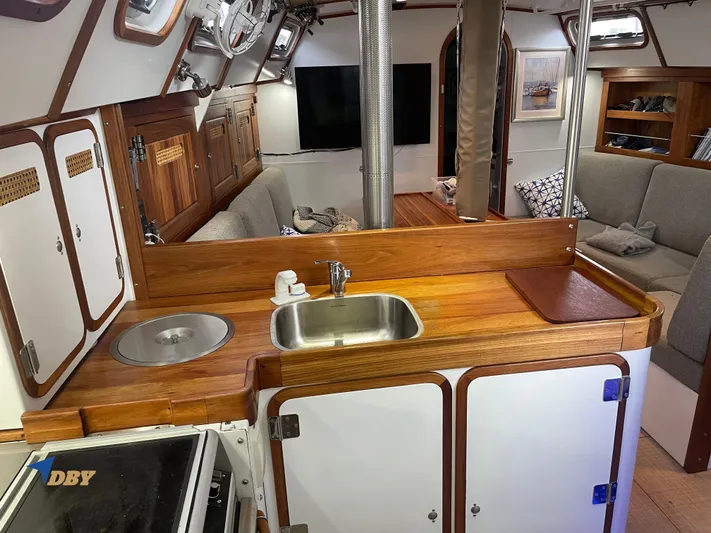 Rubicon Yacht Photos Pics Interior of 2022 Radford 15.2 yacht with wooden kitchen and cozy seating area.