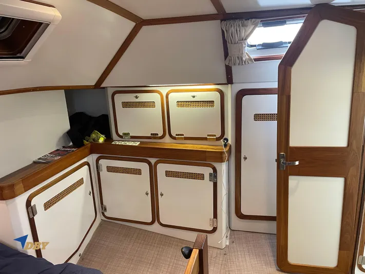 Rubicon Yacht Photos Pics Cozy interior of 2022 Radford 15.2 yacht with wooden cabinets and natural light.