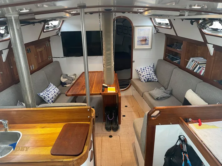 Rubicon Yacht Photos Pics Interior of 2022 Radford 15.2 sailboat with cozy seating and wooden accents.
