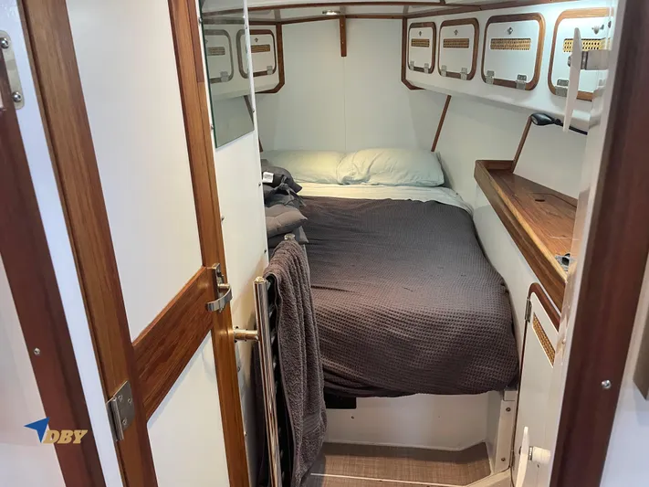 Rubicon Yacht Photos Pics Cozy cabin interior of 2022 Radford 15.2 yacht with bed and wooden accents.