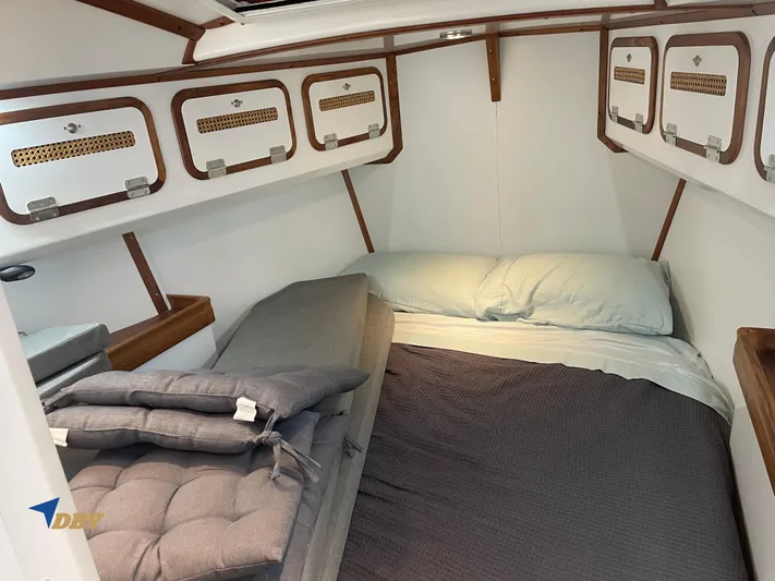 Rubicon Yacht Photos Pics Cozy cabin interior of 2022 Radford 15.2 with comfortable bedding and storage.
