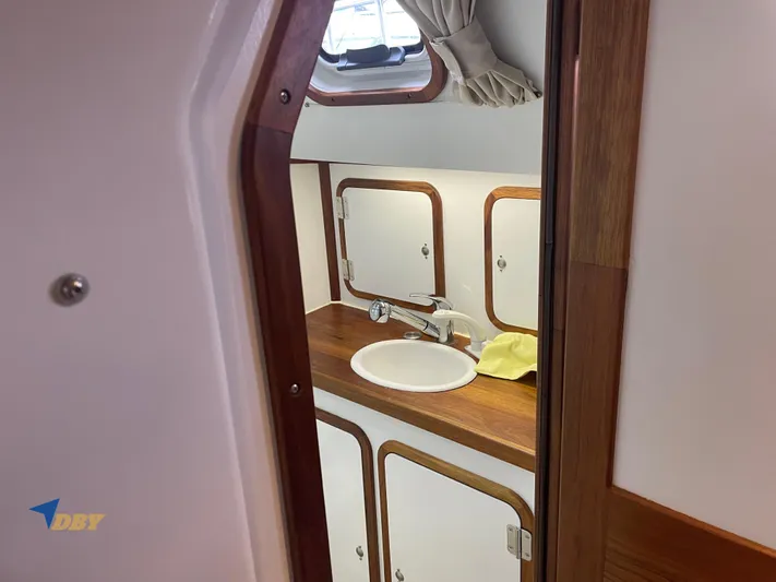 Rubicon Yacht Photos Pics Interior of 2022 Radford 15.2 yacht bathroom with wooden accents and sink.