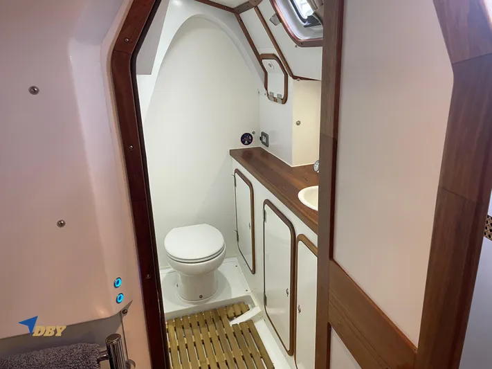 Rubicon Yacht Photos Pics 2022 Radford 15.2 yacht bathroom with wooden accents and modern fixtures.
