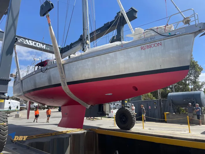 Rubicon Yacht Photos Pics 2022 Radford 15.2 sailboat, named Rubicon, lifted by crane in a shipyard.