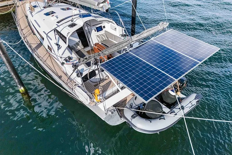  Yacht Photos Pics Sailboat Garcia 45 Explorer 2025 with solar panels and dinghy, docked on calm water.