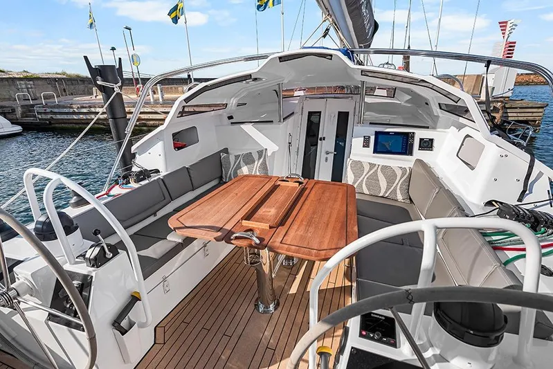  Yacht Photos Pics Luxurious 2025 Garcia 45 Explorer yacht cockpit with wooden table and seating.