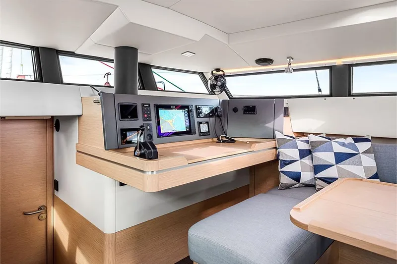  Yacht Photos Pics Modern interior of 2025 Garcia 45 Explorer yacht with navigation equipment and seating area.