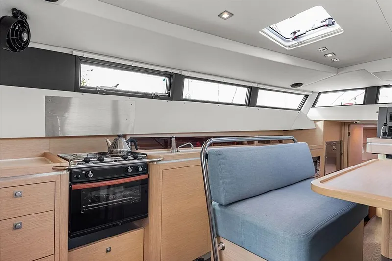  Yacht Photos Pics Modern interior of 2025 Garcia 45 Explorer yacht with kitchen and seating area.