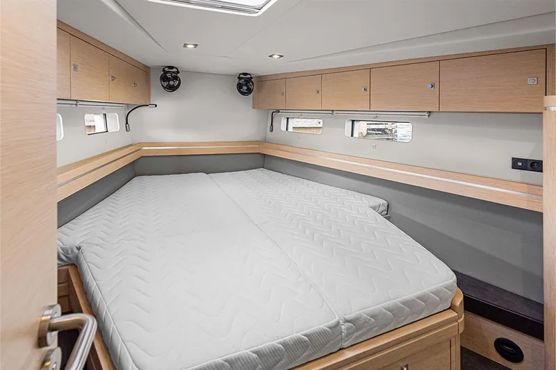  Yacht Photos Pics Luxurious cabin interior of 2025 Garcia 45 Explorer yacht with spacious bed and wooden cabinetry.