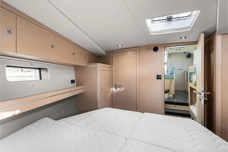  Yacht Photos Pics Interior of 2025 Garcia 45 Explorer yacht, featuring a modern bedroom with natural wood finishes.