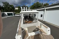 2019 Nimbus W 9 boat with Lake Constance registration, docked near modern buildings.