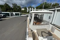 Nimbus W 9 boat, 2019 model, parked outdoors with clear canopy and wooden deck.