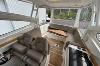 Interior of 2019 Nimbus W 9 boat with seating, table, and kitchenette.