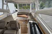 Interior of 2019 Nimbus W 9 boat with seating, table, and kitchenette.