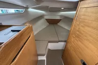 Cozy interior cabin of 2019 Nimbus W 9 boat with wooden finish and cushioned seating.