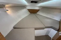 Interior cabin of 2019 Nimbus W 9 boat with beige cushions and modern lighting.