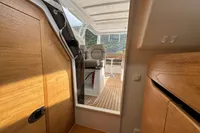 Interior of 2019 Nimbus W 9 boat with wooden finishes and seating area.