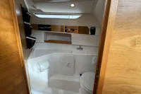 Compact bathroom interior of 2019 Nimbus W 9 boat, featuring modern fixtures and wood accents.