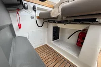 Interior of 2019 Nimbus W 9 boat with fire extinguisher and control panel.