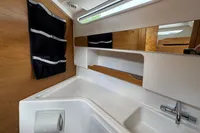 Modern bathroom interior of 2019 Nimbus W 9 boat with sleek sink and wooden accents.
