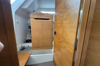 Interior of 2019 Nimbus W 9 boat with wooden cabinetry and carpeted flooring.