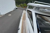 2019 Nimbus W 9 boat with Lake Constance registration, docked near a building.