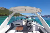 2019 Regal 26 FasDeck boat on clear blue water, scenic coastal backdrop.