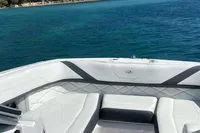 2019 Regal 26 FasDeck boat on clear blue water with scenic green hills.
