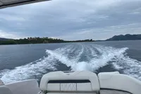 2019 Regal 26 FasDeck cruising on open water with scenic island view.