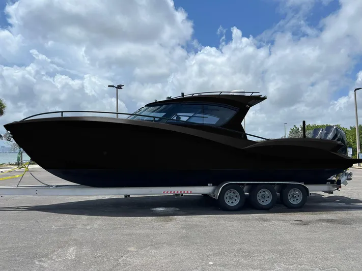 Yacht Photos Pics 2025 Novielli SERE boat on trailer under cloudy sky.