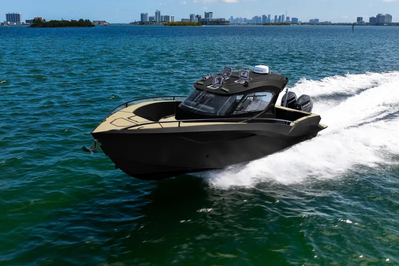  Yacht Photos Pics 2025 Novielli SERE boat cruising on open water with city skyline in background.