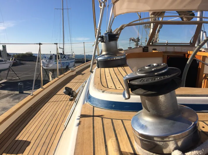 Challenger Yacht Photos Pics 1992 Hallberg-Rassy 45 yacht deck with winches and wooden finish in a marina setting.