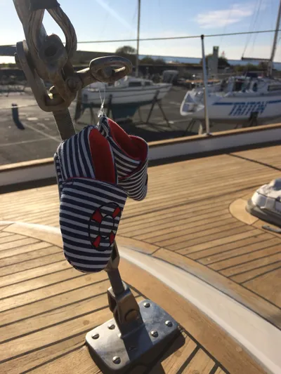 Challenger Yacht Photos Pics Striped baby shoes hanging on a 1992 Hallberg-Rassy 45 sailboat deck.