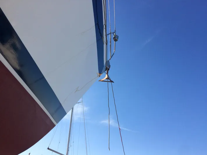 Challenger Yacht Photos Pics Hallberg-Rassy 45 sailboat bow against clear blue sky, 1992 model.
