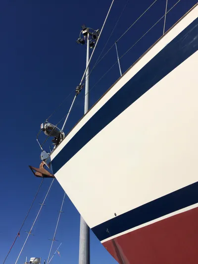 Challenger Yacht Photos Pics Sailboat Hallberg-Rassy 45, 1992 model, with blue and red stripes against clear sky.