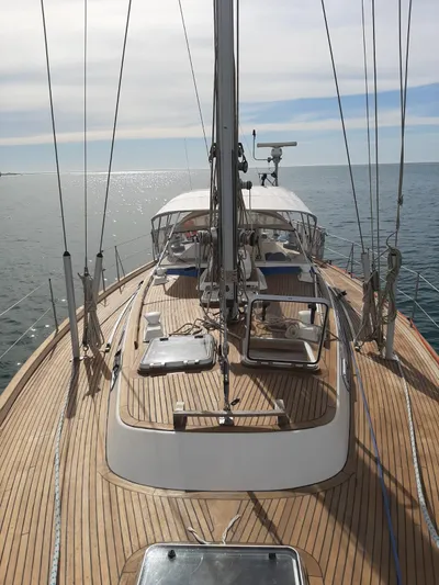 Challenger Yacht Photos Pics 1992 Hallberg-Rassy 45 yacht with wooden deck sailing on calm sea.