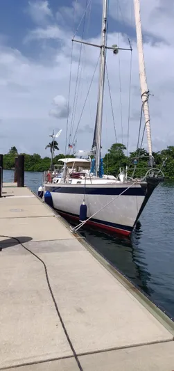 Challenger Yacht Photos Pics 1992 Hallberg-Rassy 45 sailboat docked by a calm waterfront under a clear sky.