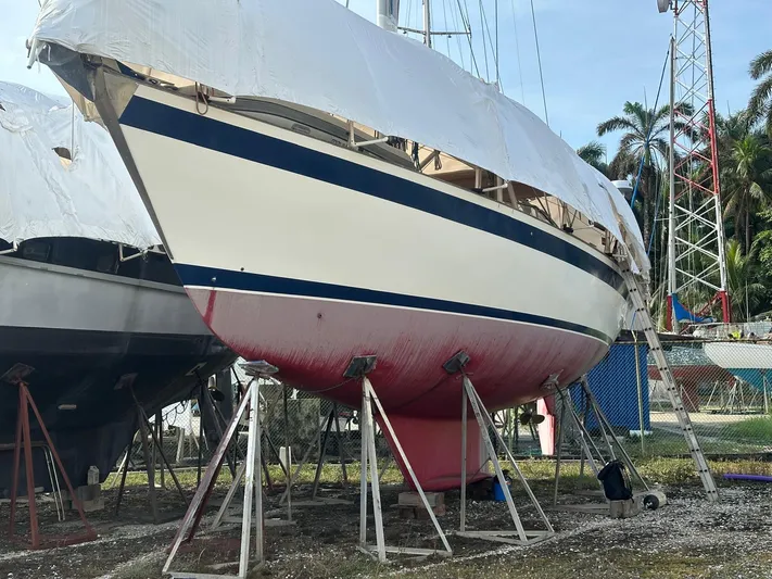 Challenger Yacht Photos Pics 1992 Hallberg-Rassy 45 sailboat on stands, partially covered, in a boatyard setting.