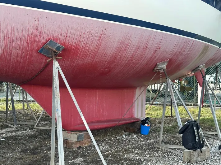 Challenger Yacht Photos Pics Hallberg-Rassy 45 sailboat hull from 1992 on stands, undergoing maintenance.