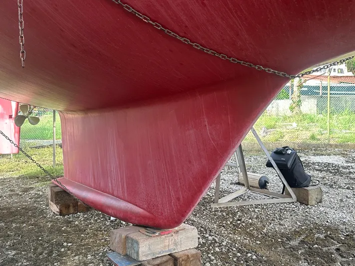 Challenger Yacht Photos Pics Red hull of a 1992 Hallberg-Rassy 45 sailboat on dry dock.