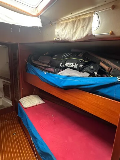 Challenger Yacht Photos Pics Interior of 1992 Hallberg-Rassy 45 sailboat with bunk beds and storage.