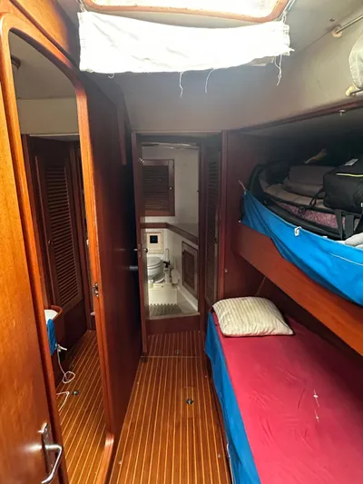Challenger Yacht Photos Pics Interior of 1992 Hallberg-Rassy 45 yacht with wooden finish and bunk beds.