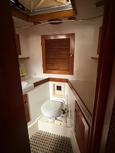 Challenger Yacht Photos Pics 1992 Hallberg-Rassy 45 yacht bathroom with wooden cabinets and compact design.