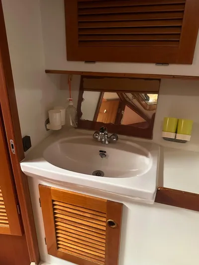 Challenger Yacht Photos Pics Bathroom sink area in a 1992 Hallberg-Rassy 45 yacht with wooden cabinetry.